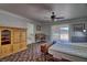 Spacious bedroom with light wood floors, ceiling fan, cabinet, and sliding doors at 4211 Bradley Rd, Las Vegas, NV 89130