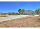 Exterior view of a home with a long driveway and a detached garage at 4211 Bradley Rd, Las Vegas, NV 89130