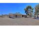 Exterior of a single-story home with a cozy porch and a spacious yard at 4211 Bradley Rd, Las Vegas, NV 89130