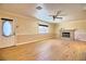 Inviting living room boasts laminate flooring, a charming fireplace, and a large window for natural light at 4211 Bradley Rd, Las Vegas, NV 89130