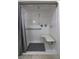 Clean, all-white shower stall with a built-in seat, grab bars, and modern fixtures at 4211 Bradley Rd, Las Vegas, NV 89130