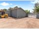 Back exterior of home with a large parking area, gravel, and block wall perimeter fence at 4620 Pacer Ave, North Las Vegas, NV 89031