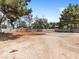 Large backyard with perimeter fencing, mature trees, and ample room for activities at 4620 Pacer Ave, North Las Vegas, NV 89031
