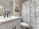 Stylish bathroom featuring a white vanity, black fixtures, and a shower with a patterned curtain at 4620 Pacer Ave, North Las Vegas, NV 89031