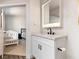 Elegant bathroom featuring a white vanity with black hardware and a view into the bedroom at 4620 Pacer Ave, North Las Vegas, NV 89031