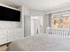Bright bedroom with a large bed, a TV, and a view of a playhouse, perfect for Gathering living at 4620 Pacer Ave, North Las Vegas, NV 89031