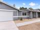 Home exterior with attached garage, gravel landscaping and updated paint scheme at 4620 Pacer Ave, North Las Vegas, NV 89031