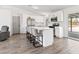 Well-lit kitchen with a kitchen island, seating, and modern appliances at 4620 Pacer Ave, North Las Vegas, NV 89031