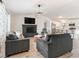 Open-concept living space with modern furnishings and a fireplace that leads to an updated kitchen and dining area at 4620 Pacer Ave, North Las Vegas, NV 89031