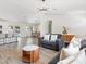 Open concept living room with modern light fixture, wood flooring, and seamlessly connects to the kitchen and dining area at 4620 Pacer Ave, North Las Vegas, NV 89031