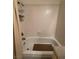 Bright white tiled bathtub and shower combination with neutral shower curtain at 4662 Kelly Barry Way, Las Vegas, NV 89121