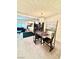 Open dining area with stylish chandelier and artwork, flowing into the living space at 4662 Kelly Barry Way, Las Vegas, NV 89121