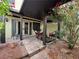 Serene patio with a seating area, surrounded by lush foliage and vibrant flowers at 4662 Kelly Barry Way, Las Vegas, NV 89121