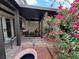 Relaxing outdoor patio space with charming seating area and lush landscaping at 4662 Kelly Barry Way, Las Vegas, NV 89121