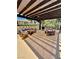 A covered outdoor patio area with comfortable seating, and stylish decor at 4662 Kelly Barry Way, Las Vegas, NV 89121
