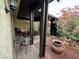 Charming covered patio area with brick flooring and comfortable seating, adjacent to a vibrant garden at 4662 Kelly Barry Way, Las Vegas, NV 89121