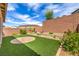 Landscaped backyard with manicured bushes and new brick wall at 48 Verde Rosa Dr, Henderson, NV 89011