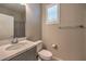 Bright bathroom featuring a large mirror, toilet, and sink with faucet at 48 Verde Rosa Dr, Henderson, NV 89011