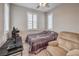 Neutral bedroom with plantation shutters, desk, and comfortable armchair at 48 Verde Rosa Dr, Henderson, NV 89011