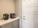 Coffee bar area with white countertops, gray cabinets, and dual Keurig coffee makers at 48 Verde Rosa Dr, Henderson, NV 89011