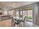 Bright dining area with sliding glass doors leading to the backyard, adjacent to kitchen at 48 Verde Rosa Dr, Henderson, NV 89011