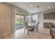 Bright dining area with sliding glass doors leading to the backyard, adjacent to kitchen at 48 Verde Rosa Dr, Henderson, NV 89011