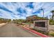 Community entrance featuring desert landscaping and rock wall with 'Alta Fiore' sign at 48 Verde Rosa Dr, Henderson, NV 89011