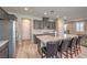 Well-equipped kitchen with stainless steel appliances, gray cabinetry and island seating at 48 Verde Rosa Dr, Henderson, NV 89011