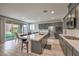 Modern kitchen featuring gray cabinets, stainless steel appliances, and a large island with seating at 48 Verde Rosa Dr, Henderson, NV 89011
