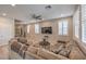 Comfortable living room with a cozy sectional sofa, bright windows, and modern decor at 48 Verde Rosa Dr, Henderson, NV 89011