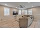 Comfortable living room with a cozy sectional sofa, bright windows, and modern decor at 48 Verde Rosa Dr, Henderson, NV 89011