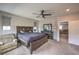 Cozy bedroom with a large bed frame, dresser, and comfortable armchair at 48 Verde Rosa Dr, Henderson, NV 89011