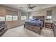 Spacious main bedroom with a dark wood bed frame and large windows at 48 Verde Rosa Dr, Henderson, NV 89011