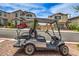 Street view showing an oversized golf cart parked on paver driveway in a neighborhood of upscale homes at 48 Verde Rosa Dr, Henderson, NV 89011