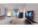 Spacious bedroom featuring gray carpet, a window, and modern TV and dresser at 50 Belle La Blanc Ave, Las Vegas, NV 89123