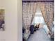 Cozy bedroom area separated by a curtain, featuring a bed and desk area with a bright window at 50 Belle La Blanc Ave, Las Vegas, NV 89123