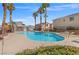 Inviting community pool area with palm trees, lounge chairs, and covered seating at 50 Belle La Blanc Ave, Las Vegas, NV 89123