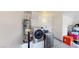 Functional laundry area with modern washer and dryer, and a water heater at 50 Belle La Blanc Ave, Las Vegas, NV 89123
