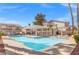 Community pool with a pergola area, a tanning ledge, and blue skies, perfect for relaxation at 50 Belle La Blanc Ave, Las Vegas, NV 89123