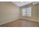 A well-lit bedroom showcases light colored walls, ceiling fan, and wood vinyl flooring at 50 E Serene Ave # 420, Las Vegas, NV 89123