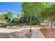 Walking path leads to reflective glass building with meticulous landscaping at 50 E Serene Ave # 420, Las Vegas, NV 89123