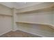 Walk-in closet with wood vinyl flooring and custom wood shelving offers ample storage space at 50 E Serene Ave # 420, Las Vegas, NV 89123