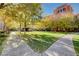 Green common area and sidewalks surrounded by colorful residential buildings at 50 E Serene Ave # 420, Las Vegas, NV 89123