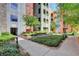 Exterior view of a colorful building with landscaped gardens, pathway, and well-kept shrubs at 50 E Serene Ave # 420, Las Vegas, NV 89123