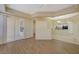 Open-concept living room with access to kitchen and balcony, featuring wood-look flooring at 50 E Serene Ave # 420, Las Vegas, NV 89123