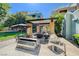 Well-equipped outdoor kitchen with built-in BBQ grill and sink, set within a pergola covered patio at 50 E Serene Ave # 420, Las Vegas, NV 89123