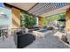 Comfortable covered outdoor space with a stone fire pit and ample seating area at 50 E Serene Ave # 420, Las Vegas, NV 89123