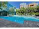 Exterior view of a sparkling blue pool surrounded by lounge chairs and contemporary buildings at 50 E Serene Ave # 420, Las Vegas, NV 89123