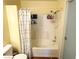 Bathroom featuring a shower and tub combo with white and gray shower curtains at 5024 Starfinder Ave, Las Vegas, NV 89108