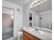 Bright bathroom featuring a vanity with solid surface countertop, and a framed mirror at 5024 Starfinder Ave, Las Vegas, NV 89108